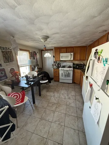 a kitchen with a stove a refrigerator and workspace