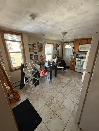 a living room with furniture a air conditioner vent and a window