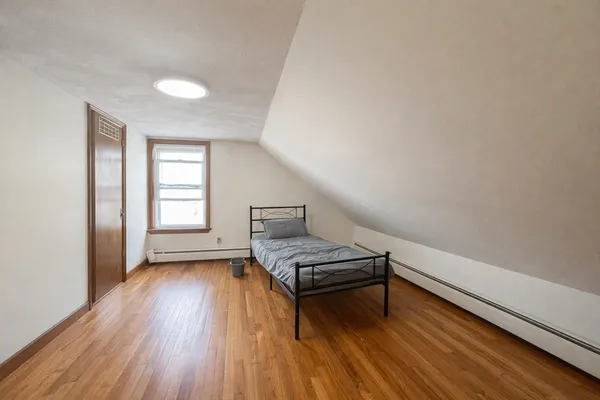 a view of room with window and wooden floor