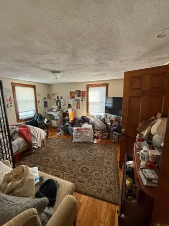 a living room with furniture a window and gym equipment
