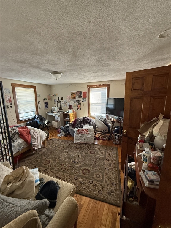 585 Somerville, Unit A1 Somerville, MA 02143 - Photo 8 of 19 a living room with furniture a window and gym equipment