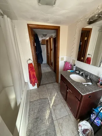 a bathroom with a sink vanity and mirror