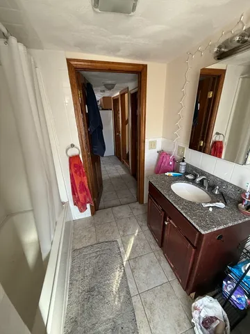a bathroom with a sink vanity and mirror