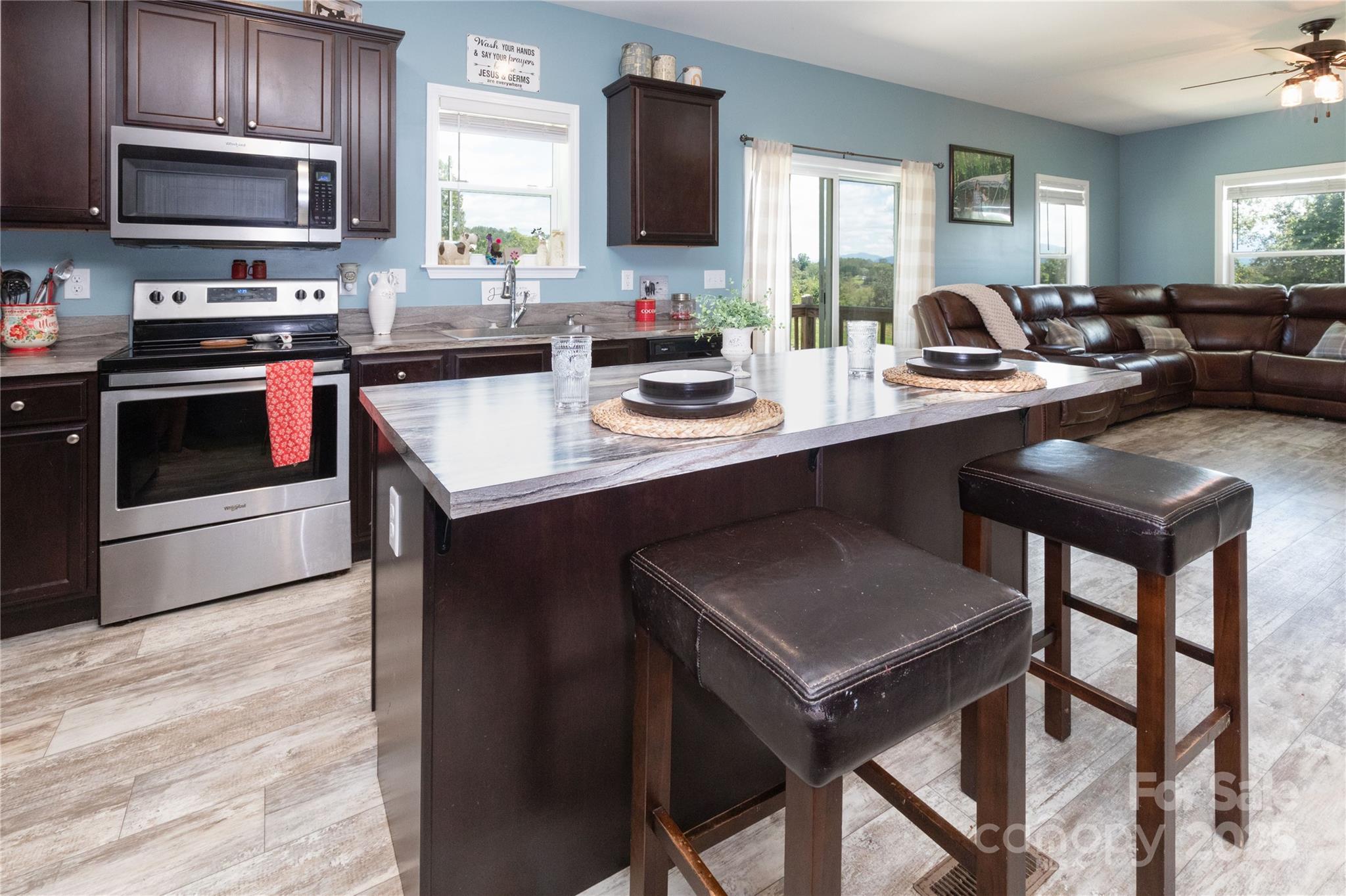 653 Mag Sluder Road Alexander, NC 28701 - Photo 13 of 28 a kitchen with sink cabinets and stainless steel appliances