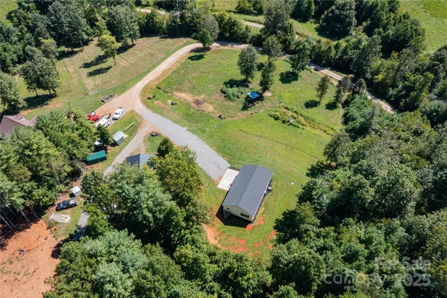 an aerial view of a house with yard swimming pool and outdoor seating
