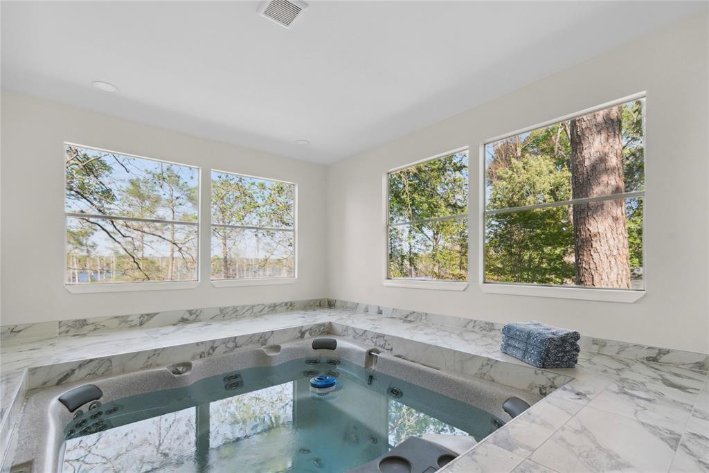 141 Mallard Road Ringgold, LA 71068 - Photo 2 of 33 Indoor spa with integrated hot tub, surrounded by white marble-look tile, and multiple windows