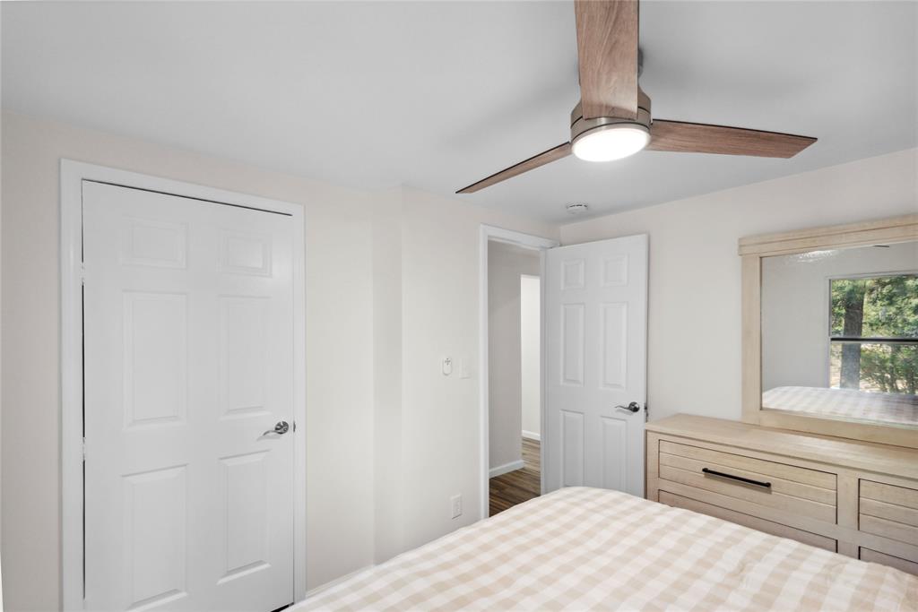 141 Mallard Road Ringgold, LA 71068 - Photo 26 of 33 Bedroom featuring a wood-finish ceiling fan with integrated lighting, white six-panel doors, and light-toned walls