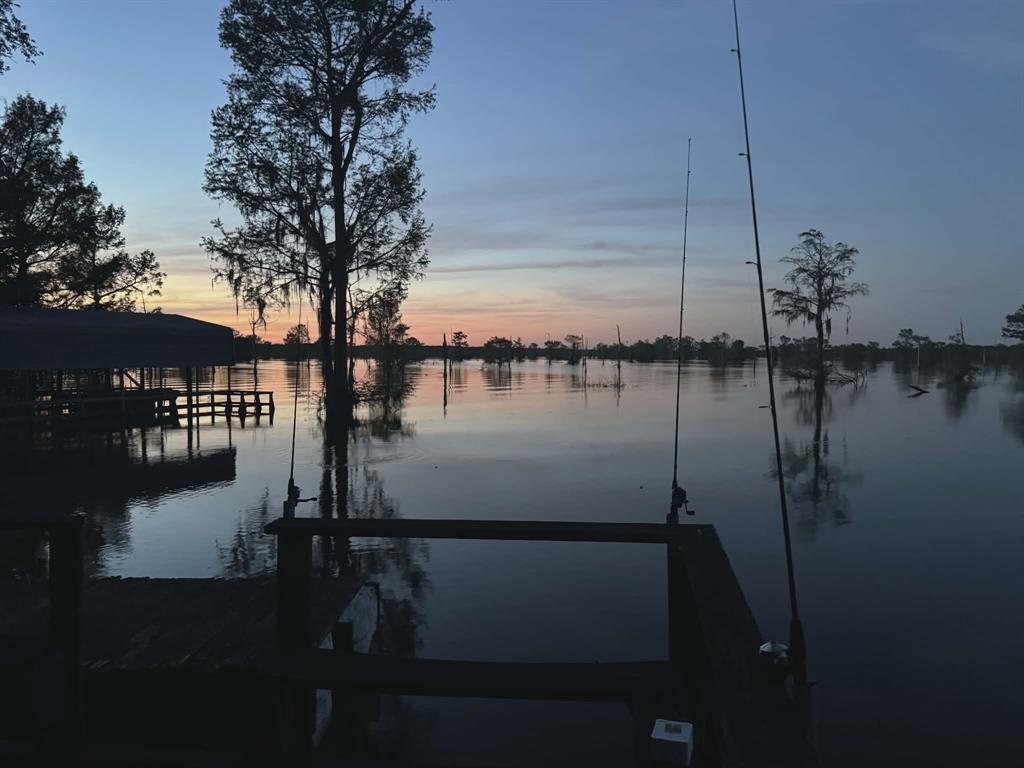 141 Mallard Road Ringgold, LA 71068 - Photo 3 of 33 Waterfront property featuring a private boat dock, covered boat slip, mature trees, and calm reflective waters