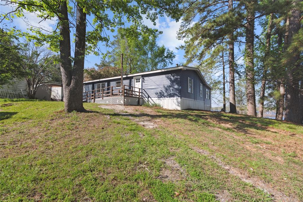 141 Mallard Road Ringgold, LA 71068 - Photo 33 of 33 Blue siding exterior with white trim, featuring a wooden deck with railing