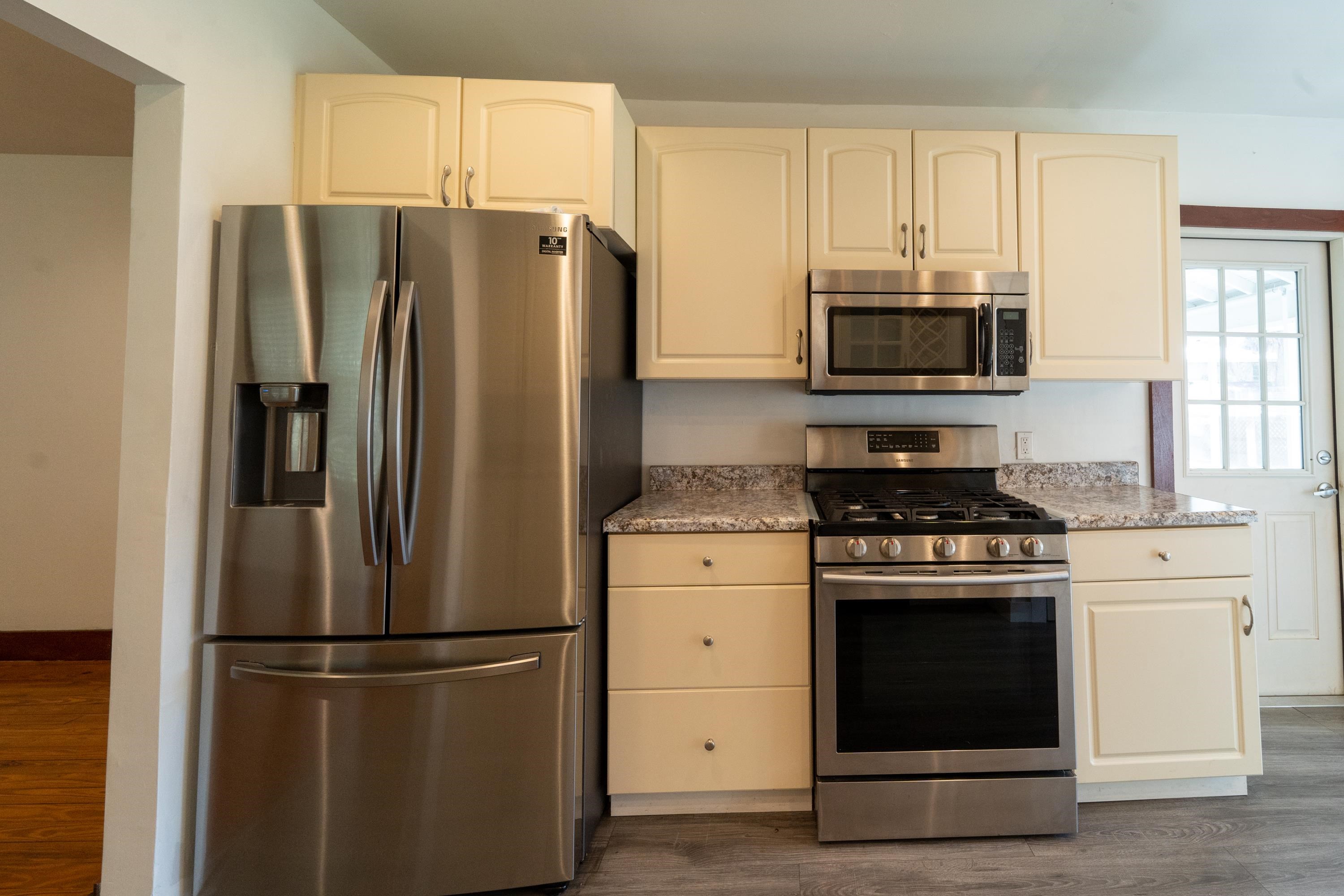 23 Hope Street St. Augustine, FL 32084 - Photo 12 of 22 a kitchen with stainless steel appliances a refrigerator stove and microwave