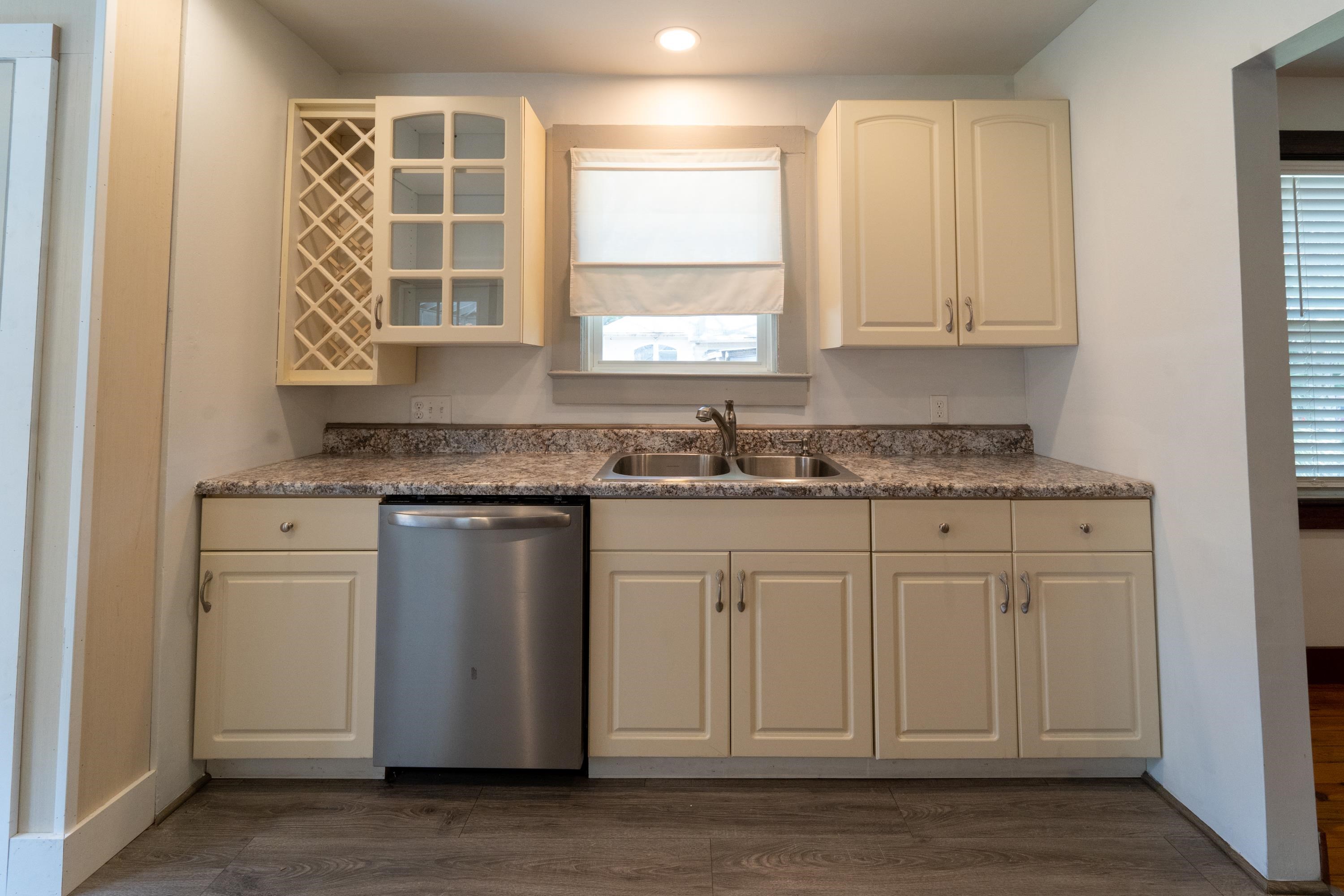 23 Hope Street St. Augustine, FL 32084 - Photo 13 of 22 a kitchen with granite countertop white cabinets stainless steel appliances a sink and a window