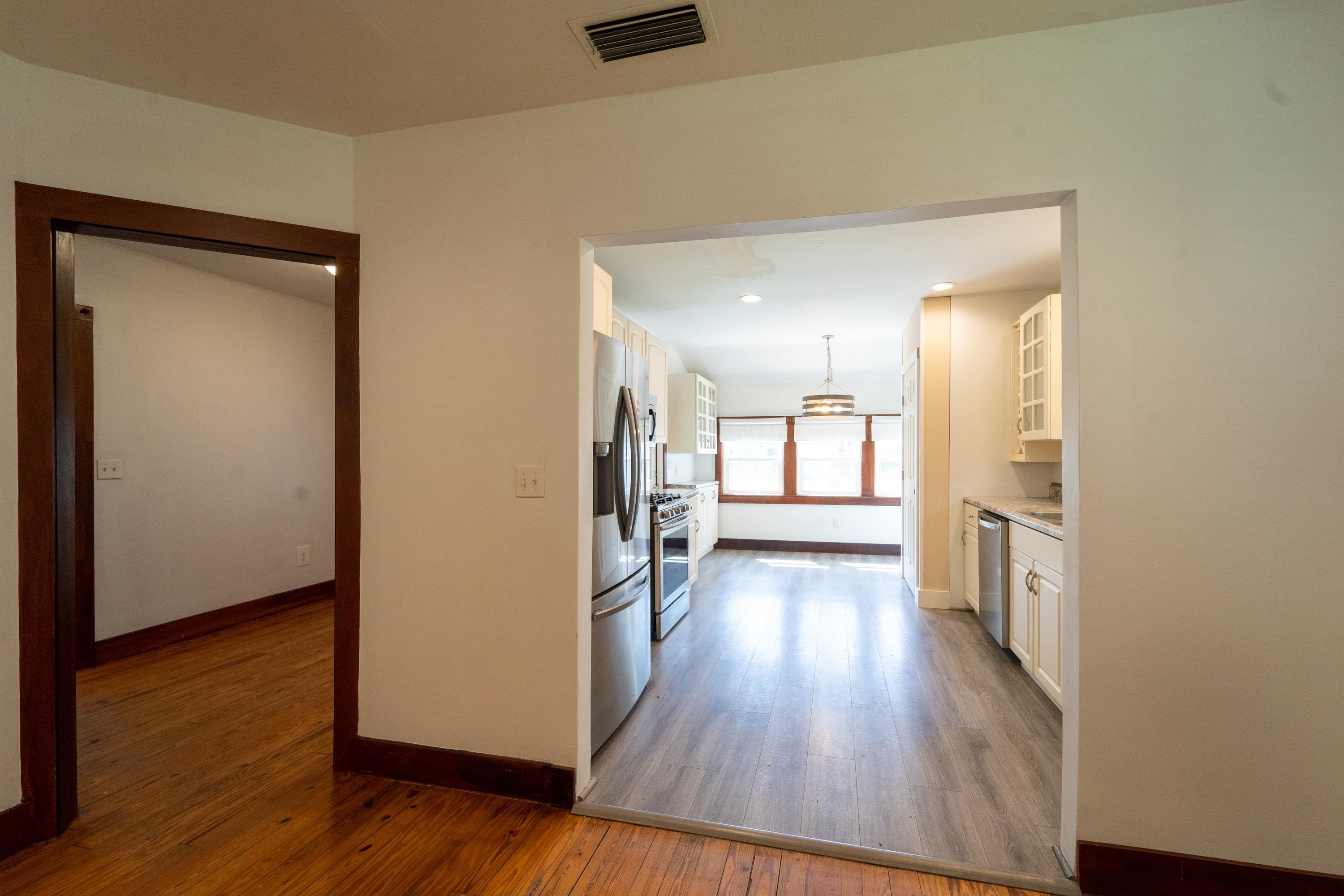23 Hope Street St. Augustine, FL 32084 - Photo 15 of 22 an empty room with wooden floor and a bathroom