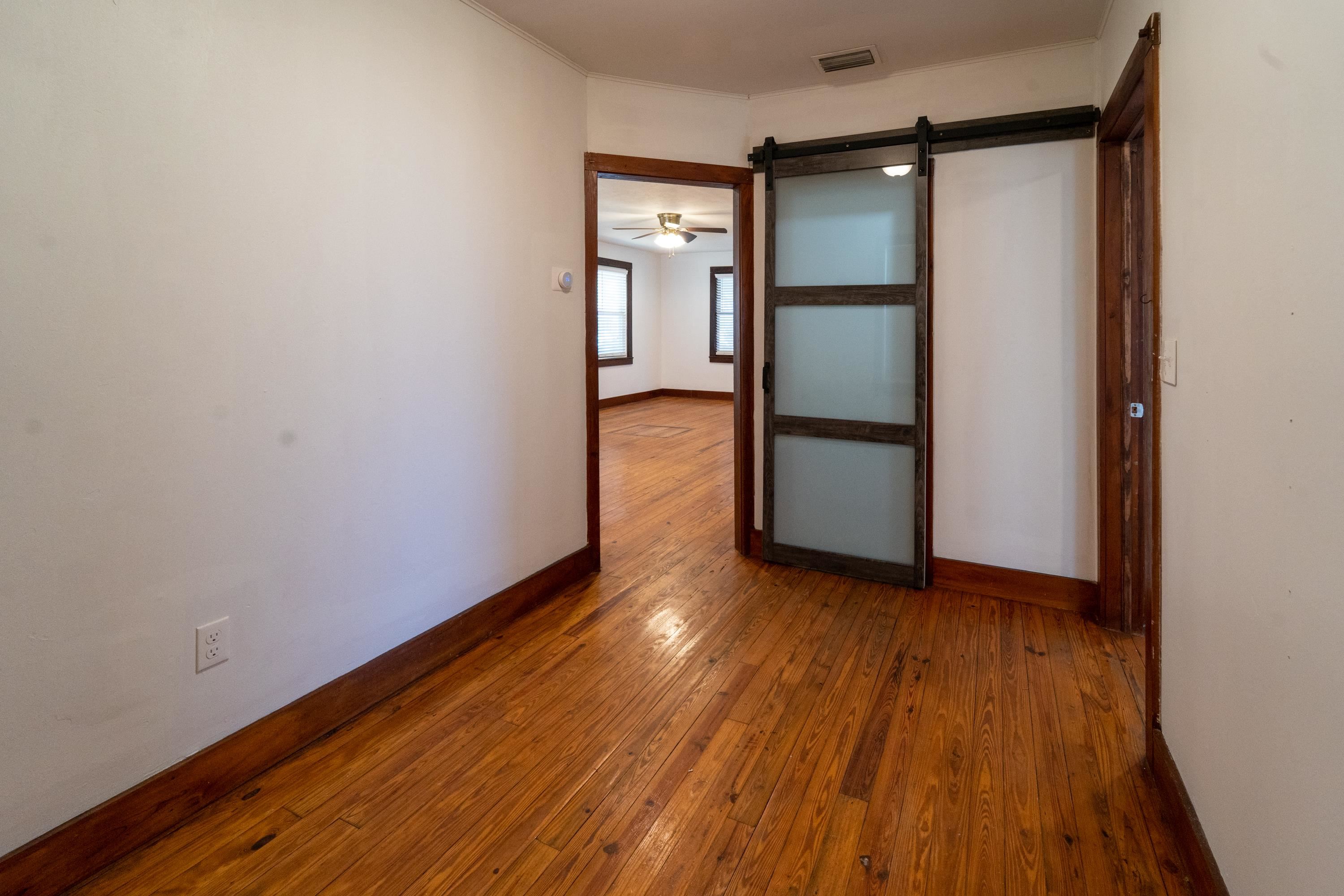 23 Hope Street St. Augustine, FL 32084 - Photo 18 of 22 a view of an empty room with wooden floor and a window