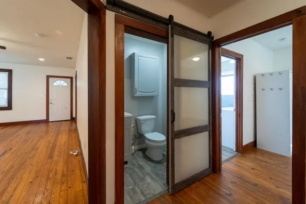 a bathroom with a glass door shower and a toilet