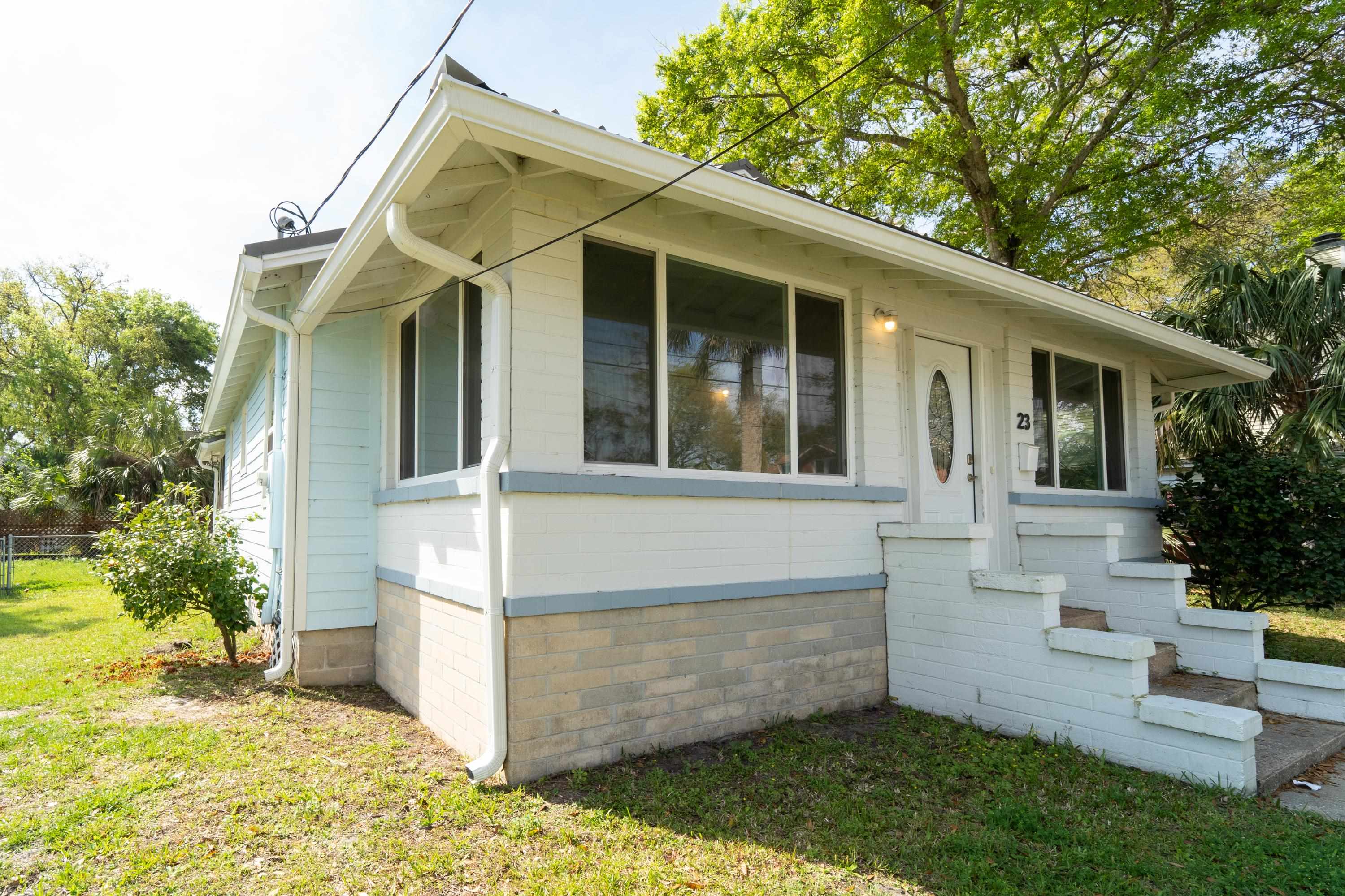 23 Hope Street St. Augustine, FL 32084 - Photo 4 of 22 a view of a white house with a small yard and large tree