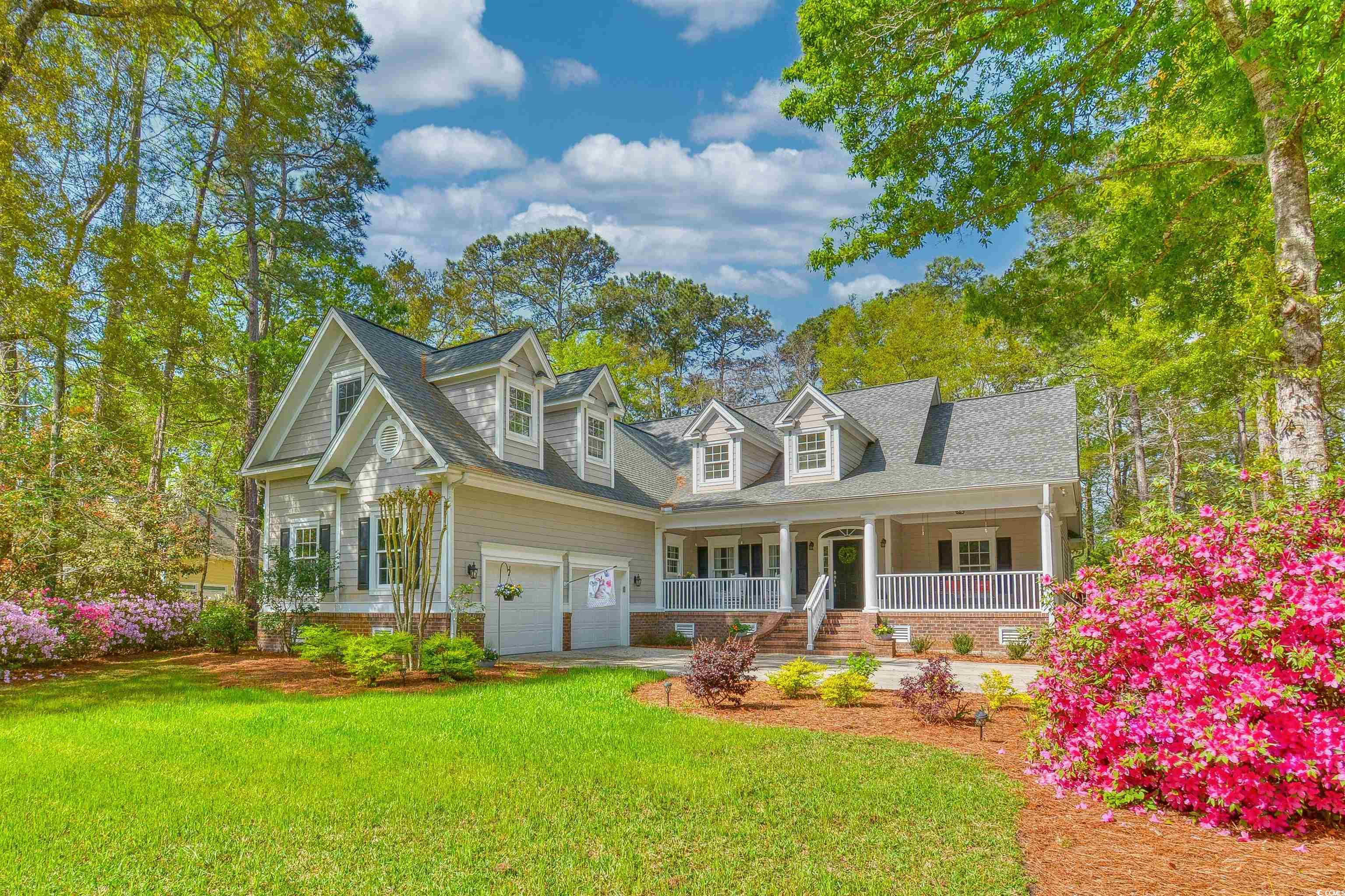 Cape cod-style house with a porch and a front yard