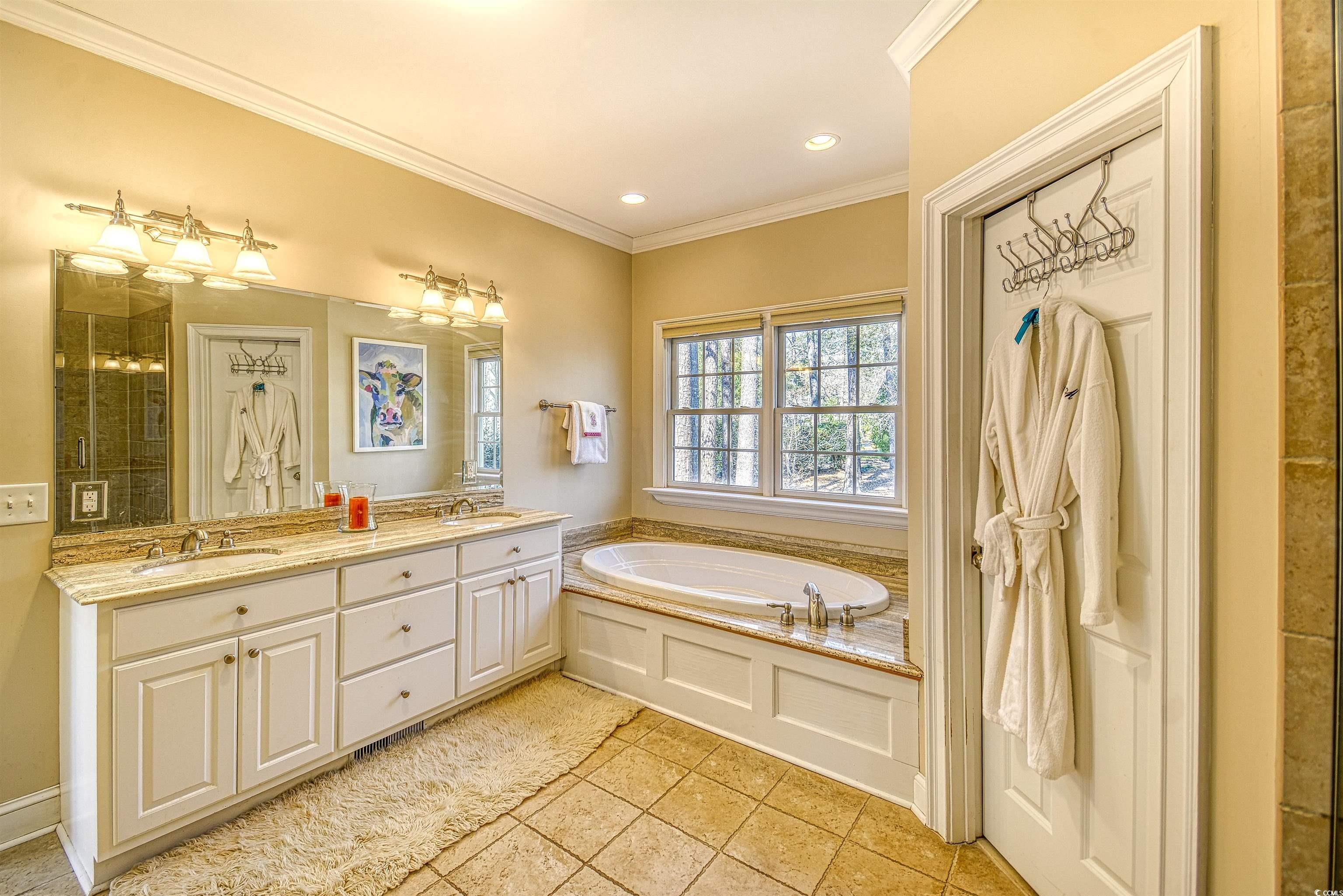 4514 Wagon Run Murrells Inlet, SC 29576 - Photo 12 of 40 Bathroom with crown molding, a garden tub, and a s