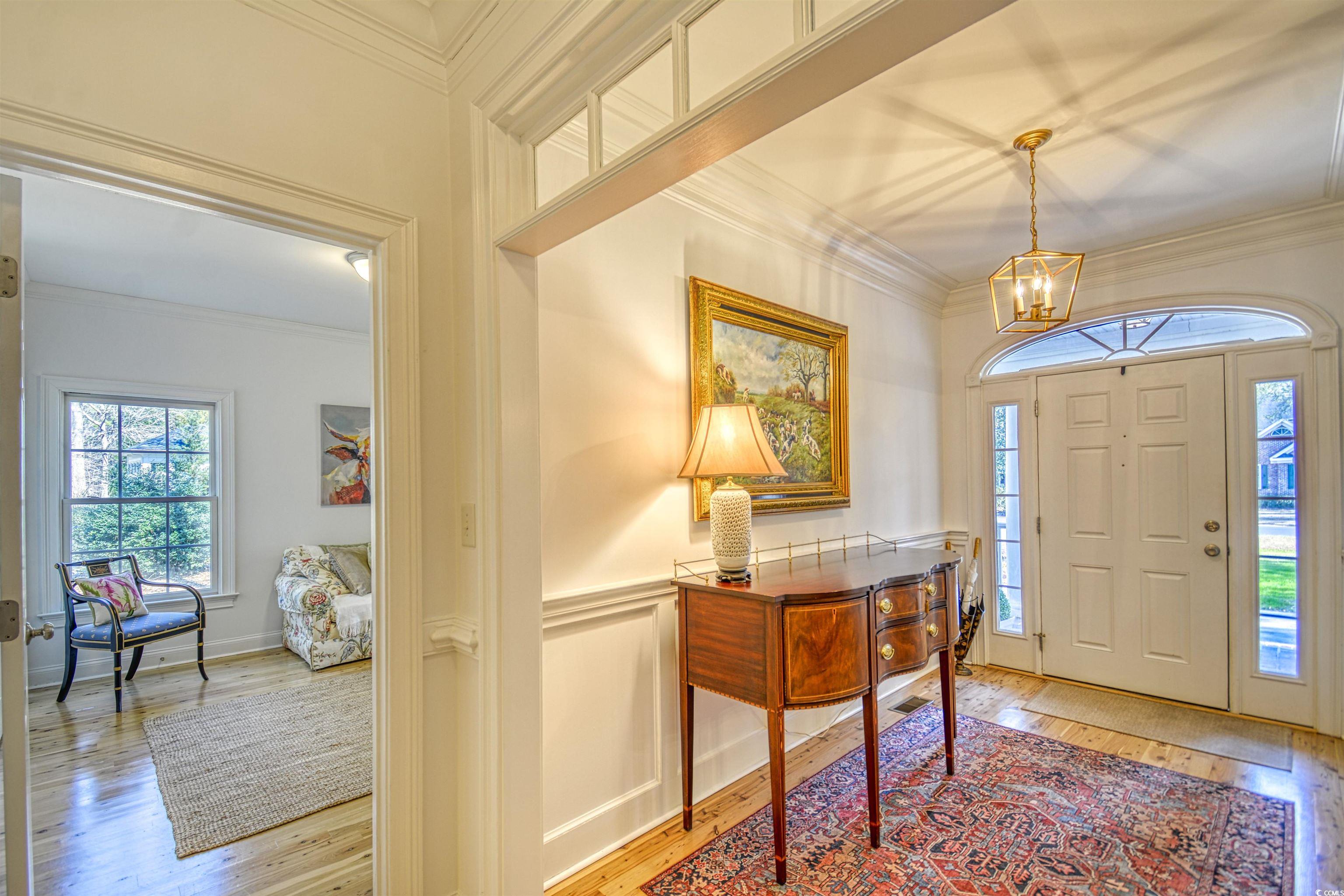 4514 Wagon Run Murrells Inlet, SC 29576 - Photo 21 of 40 Entryway featuring ornamental molding, a wainscote