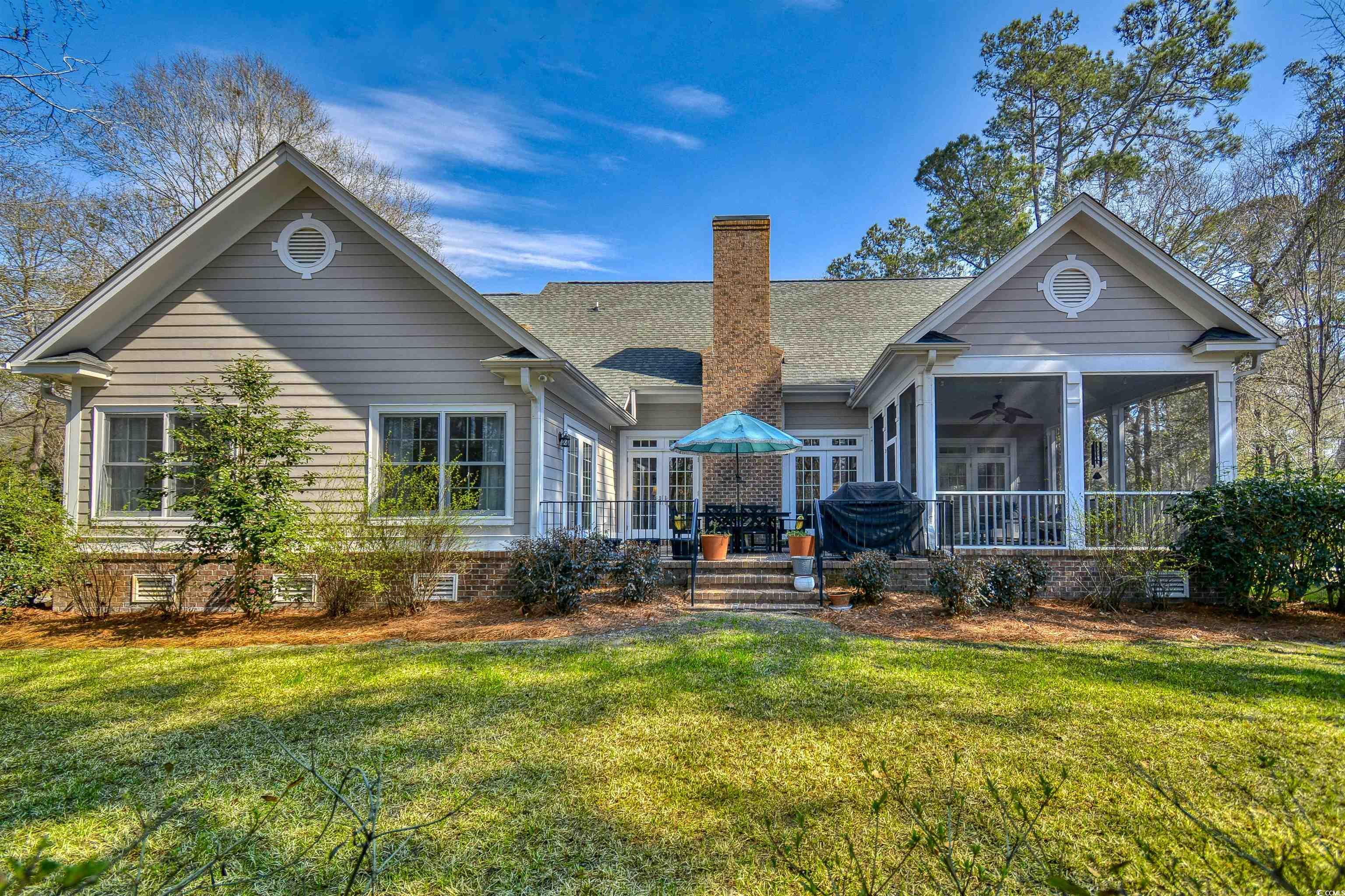 4514 Wagon Run Murrells Inlet, SC 29576 - Photo 33 of 40 Back of house featuring a shingled roof, a sunroom