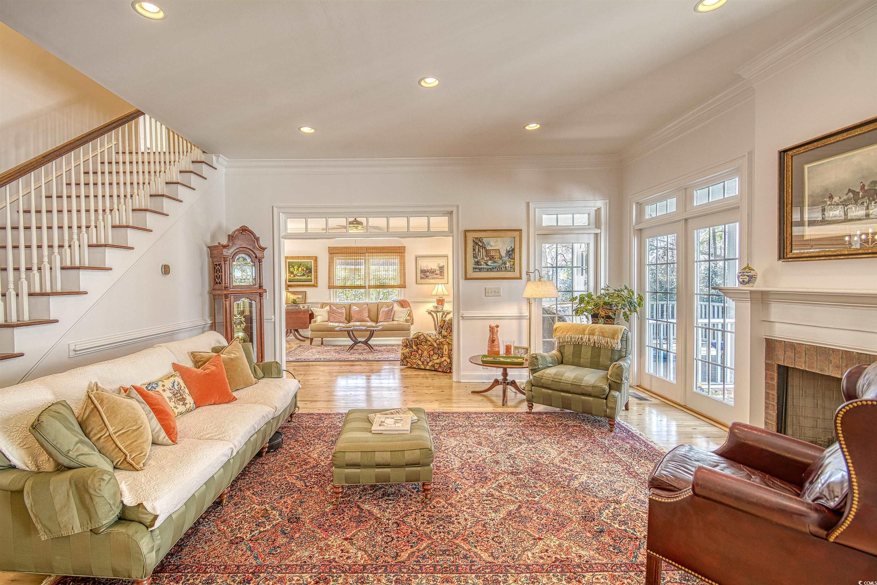 4514 Wagon Run Murrells Inlet, SC 29576 - Photo 4 of 40 Living area with a fireplace, crown molding, stair