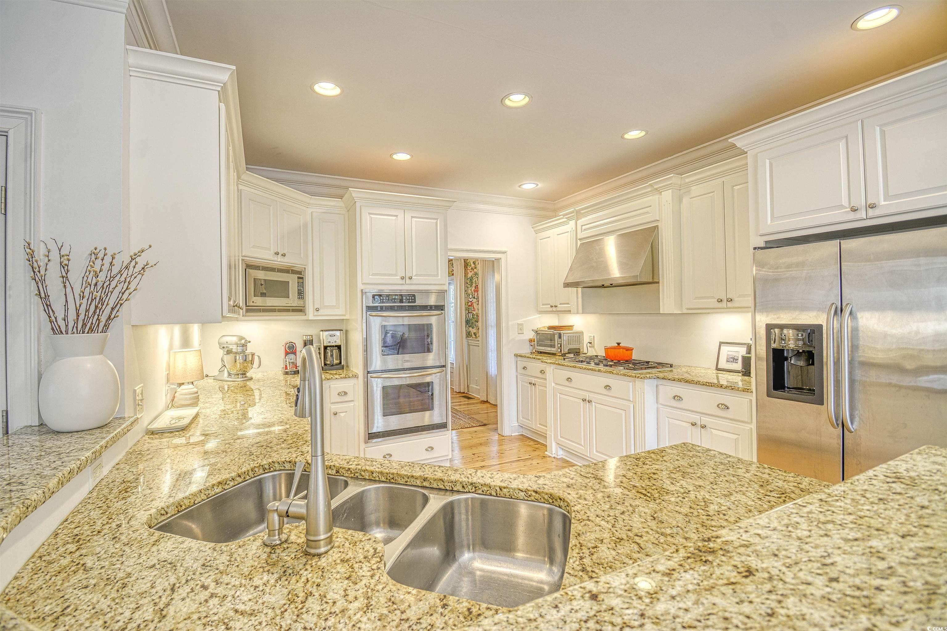4514 Wagon Run Murrells Inlet, SC 29576 - Photo 9 of 40 Kitchen with light stone counters, range hood, sta