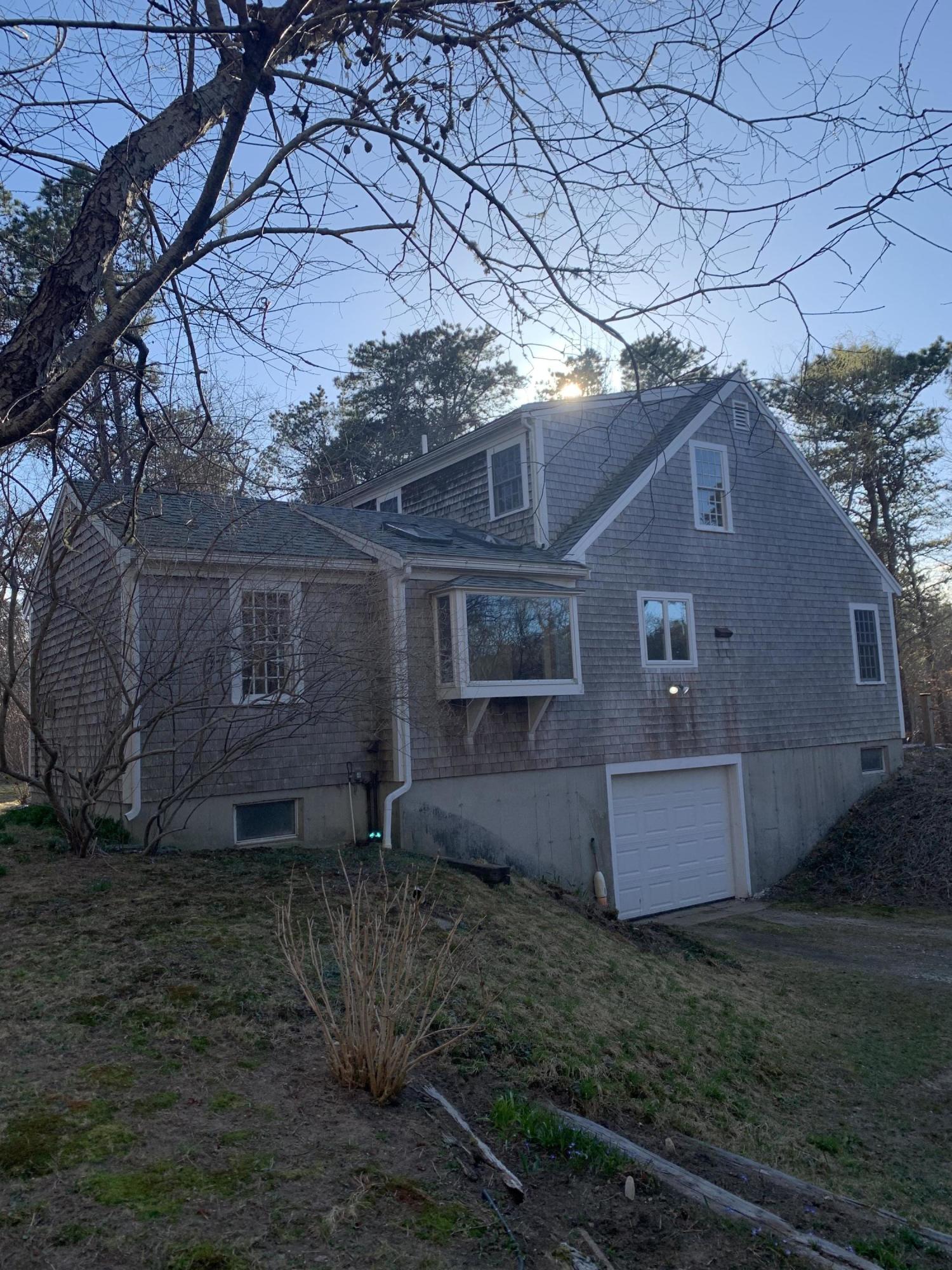 150 Browns Neck Road Wellfleet, MA 02667 - Photo 3 of 30 a view of a small house with a yard