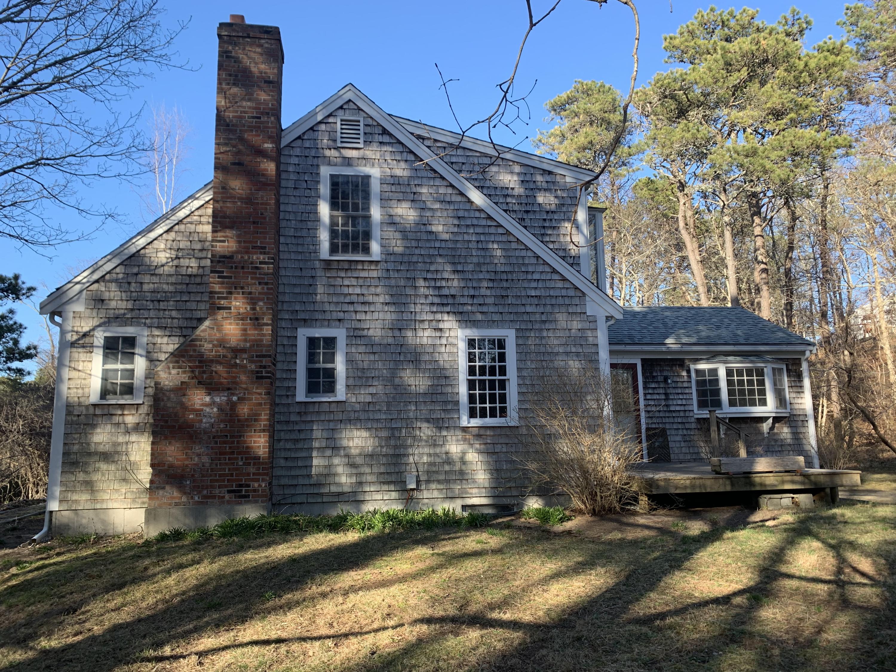150 Browns Neck Road Wellfleet, MA 02667 - Photo 5 of 30 a front view of a house with a yard