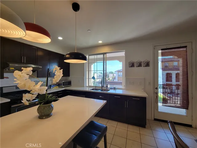 a kitchen with a refrigerator a stove and a sink