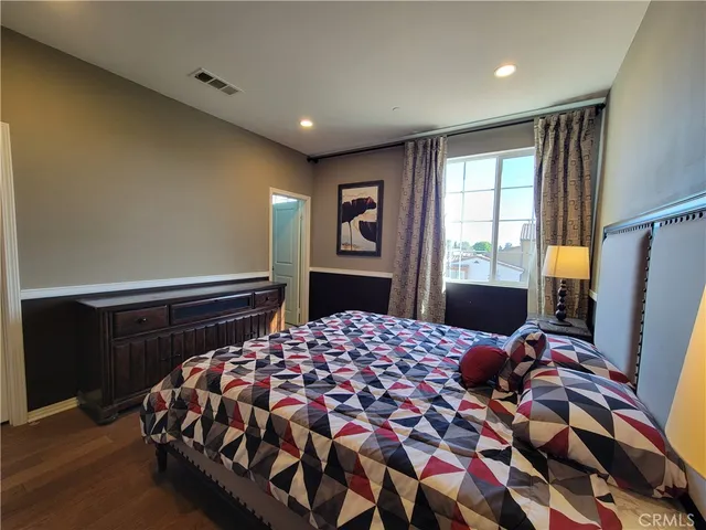 a bedroom with a large bed and a lamp