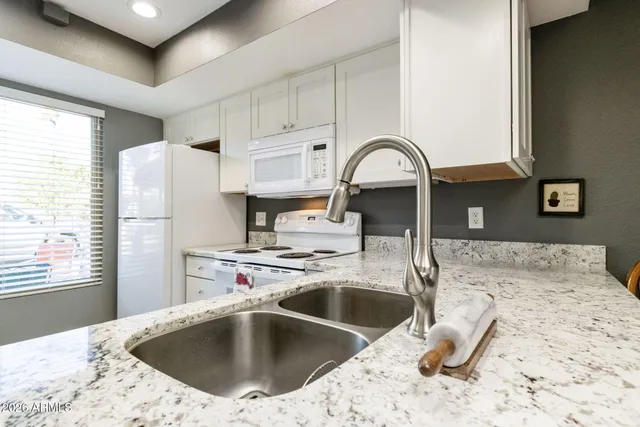 a kitchen with a sink a stove and refrigerator