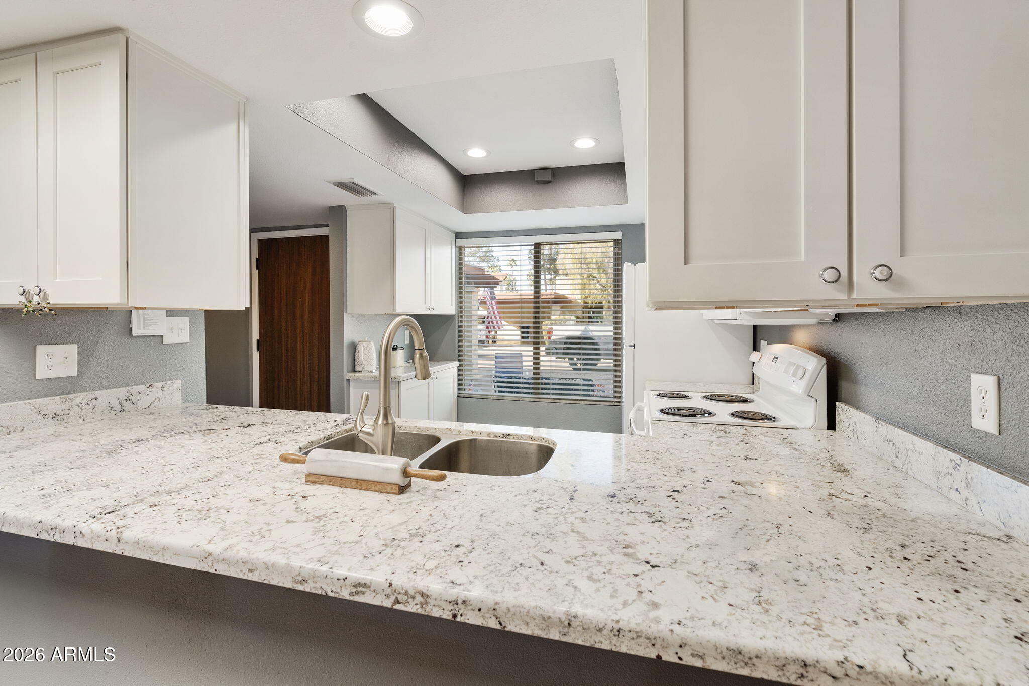 503 South Boojum Way Mesa, AZ 85208 - Photo 12 of 51 a kitchen with granite countertop a sink a stove and a wooden floors
