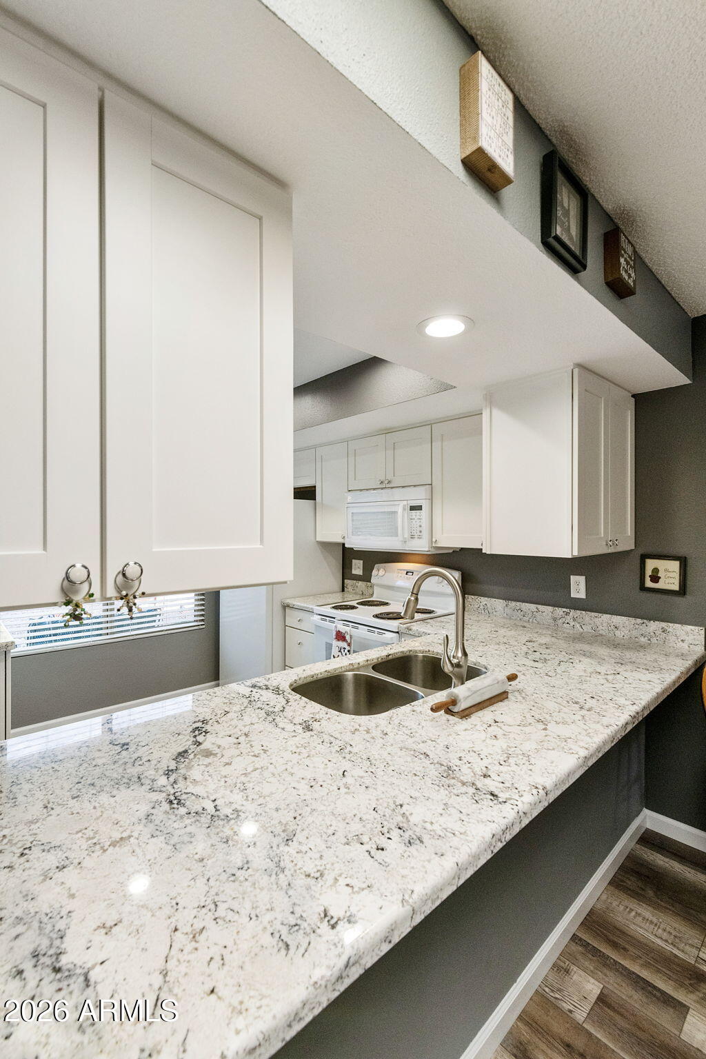 503 South Boojum Way Mesa, AZ 85208 - Photo 13 of 51 a kitchen with kitchen island granite countertop a sink and a stove top oven