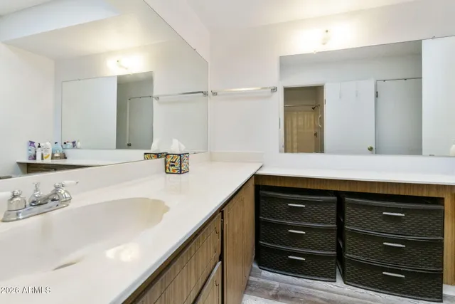 a bathroom with a sink double vanity and a mirror