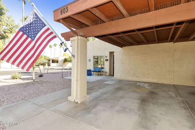 a building outdoor space with patio furniture and potted plants