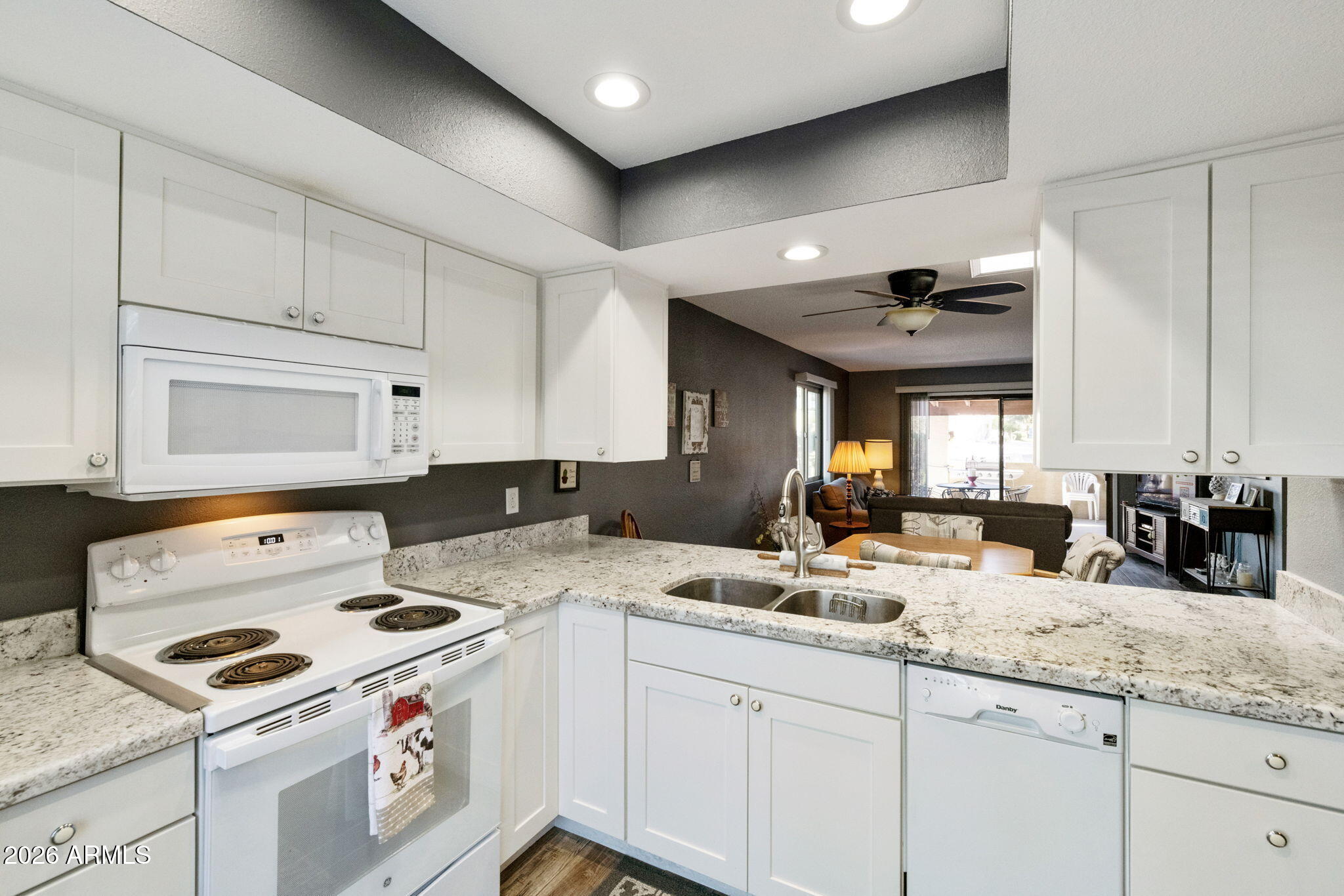 503 South Boojum Way Mesa, AZ 85208 - Photo 8 of 51 a kitchen with granite countertop a sink a stove and cabinets