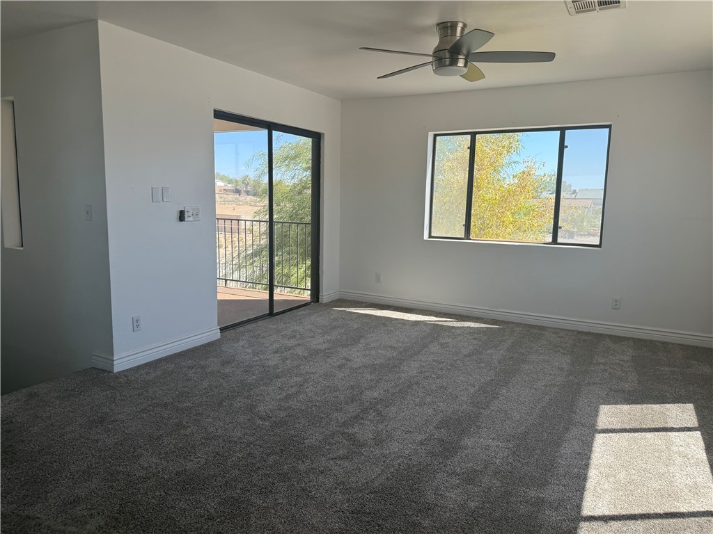 1645 Dunlap Road Fort Mohave, AZ 86426 - Photo 15 of 39 an empty room with windows and ceiling fan