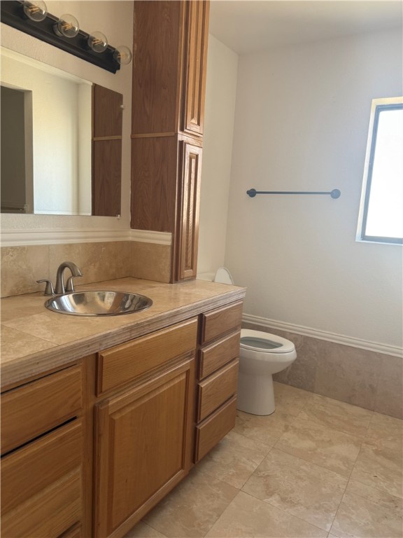 1645 Dunlap Road Fort Mohave, AZ 86426 - Photo 17 of 39 a bathroom with a toilet sink and mirror