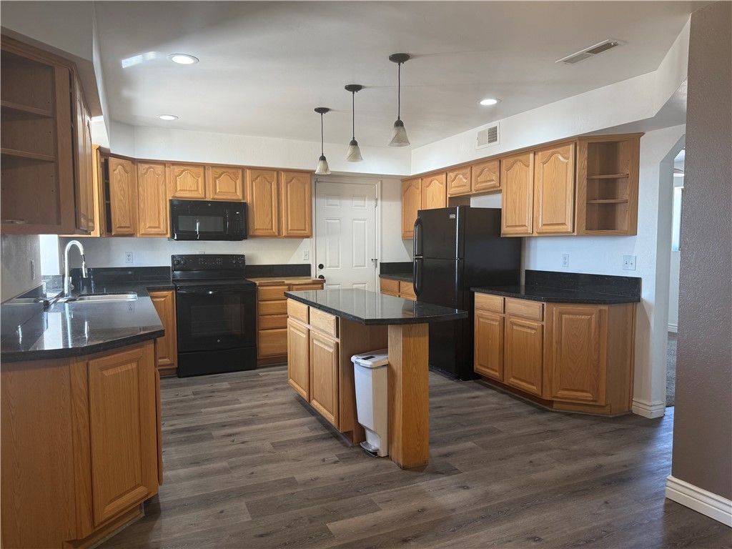 1645 Dunlap Road Fort Mohave, AZ 86426 - Photo 5 of 39 a kitchen with stainless steel appliances wooden floors and wooden cabinets