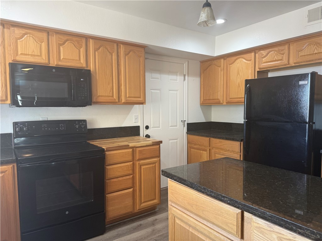 1645 Dunlap Road Fort Mohave, AZ 86426 - Photo 7 of 39 a kitchen with a refrigerator and a sink