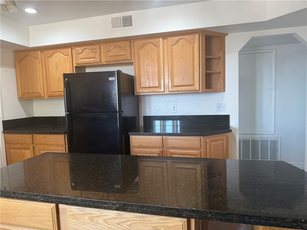 1645 Dunlap Road Fort Mohave, AZ 86426 - Photo 8 of 39 a kitchen with stainless steel appliances granite countertop a refrigerator a stove and a sink with wooden floor
