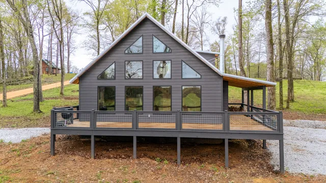 a backyard of a house with barbeque oven table and chairs