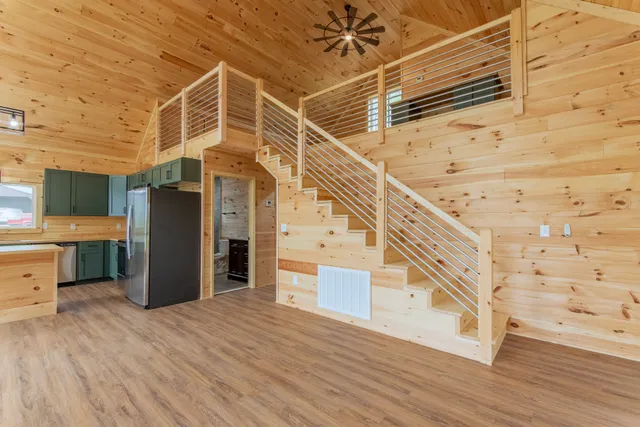 a view of a room with wooden floor and staircase