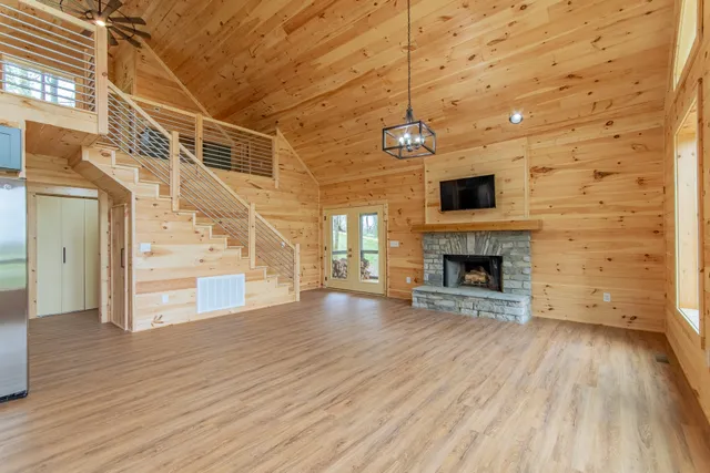 a kitchen with stainless steel appliances granite countertop a refrigerator a stove and a wooden floors