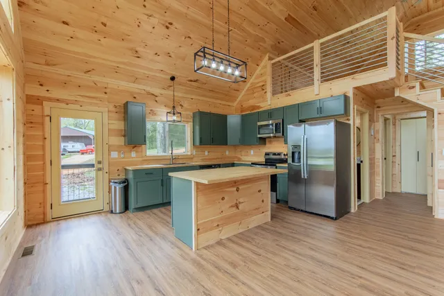 a large kitchen with a sink and large window