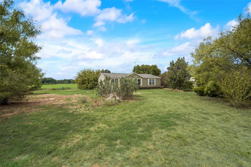 a view of a field with an trees