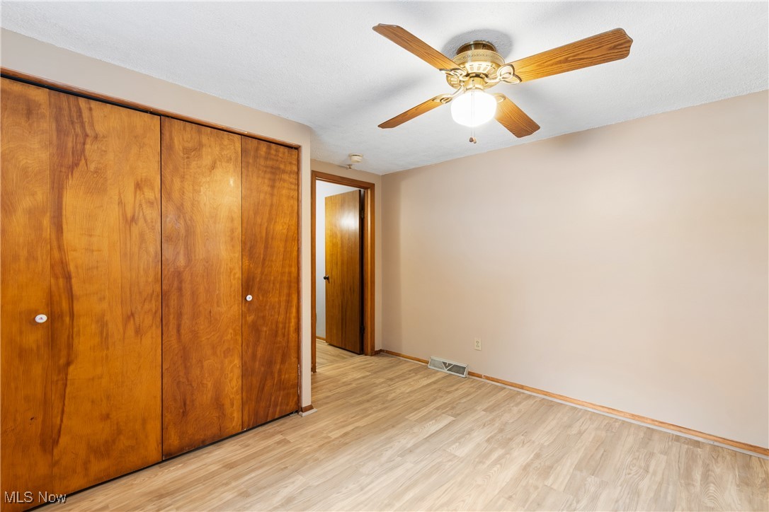 5415 12th Street Northwest Canton, OH 44708 - Photo 19 of 35 Unfurnished bedroom featuring light wood-style flooring, baseboards, visible vents, and a closet