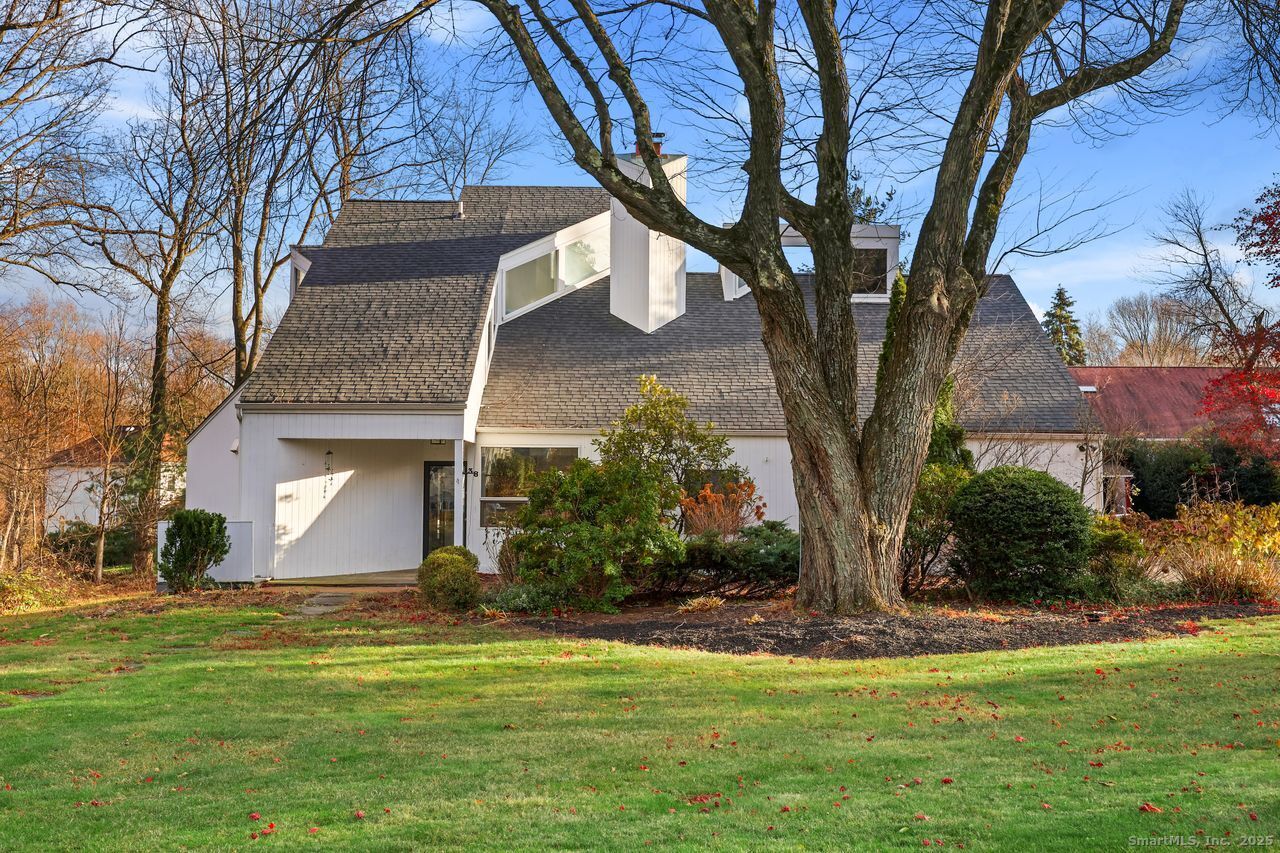 a front view of a house with a garden and yard