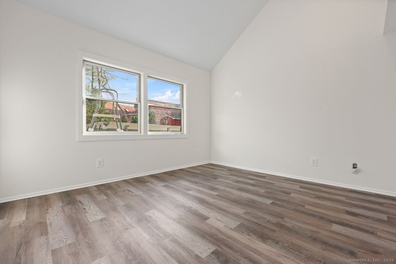 38 Chester Road Easton, CT 06612 - Photo 17 of 36 a view of an empty room with wooden floor and a window