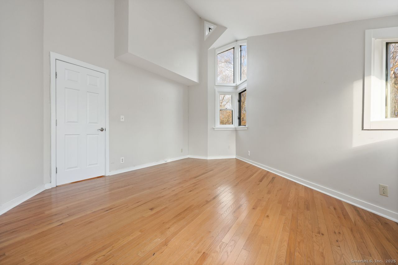 38 Chester Road Easton, CT 06612 - Photo 26 of 36 an empty room with wooden floor and windows