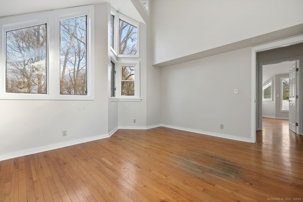 38 Chester Road Easton, CT 06612 - Photo 30 of 36 a view of an empty room with wooden floor and a window